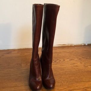Leather upper knee high boots with side zipper.
